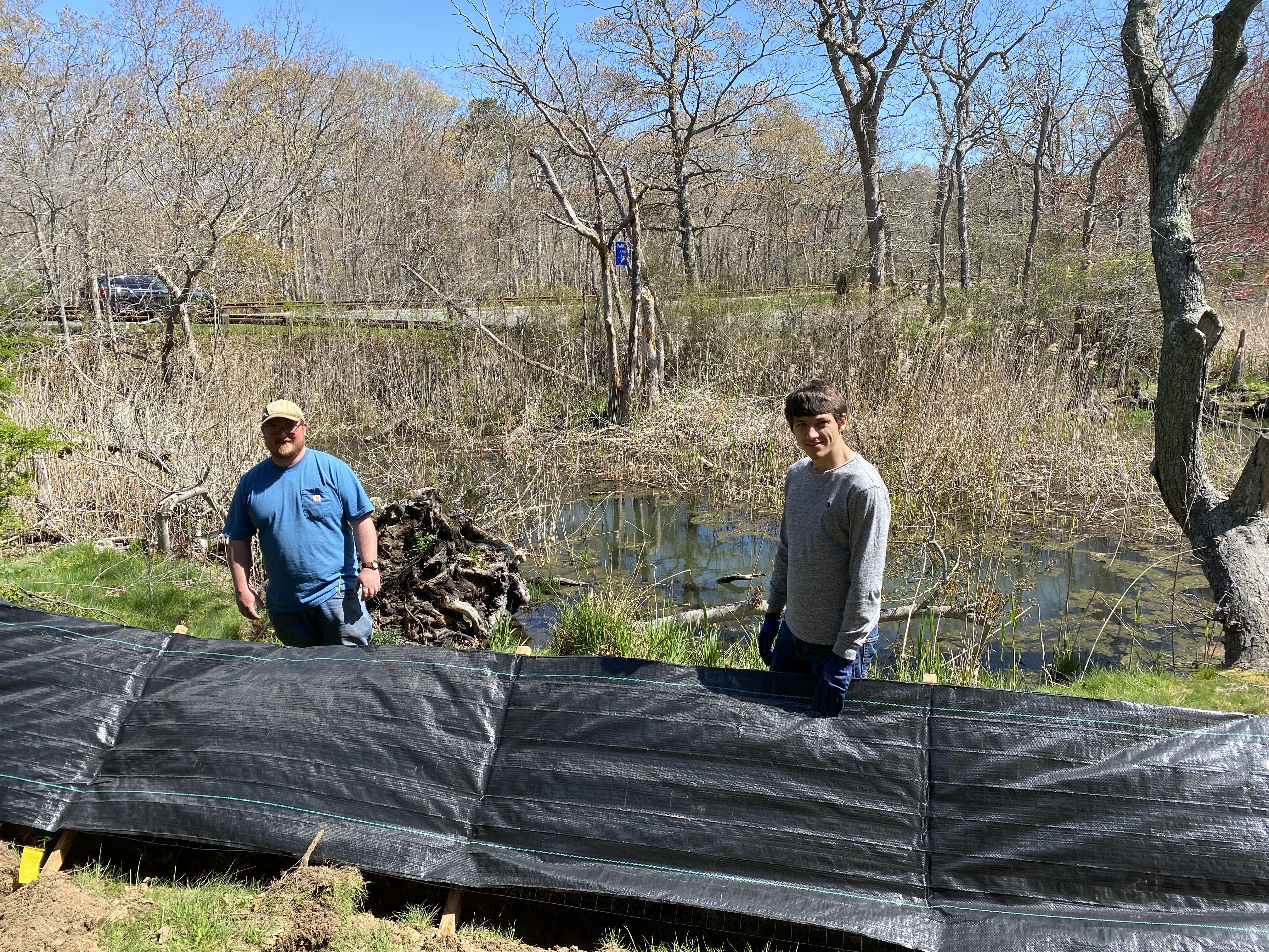 Brendan Minogue and James Brako Mc Comb installing eco barrier at Georgica