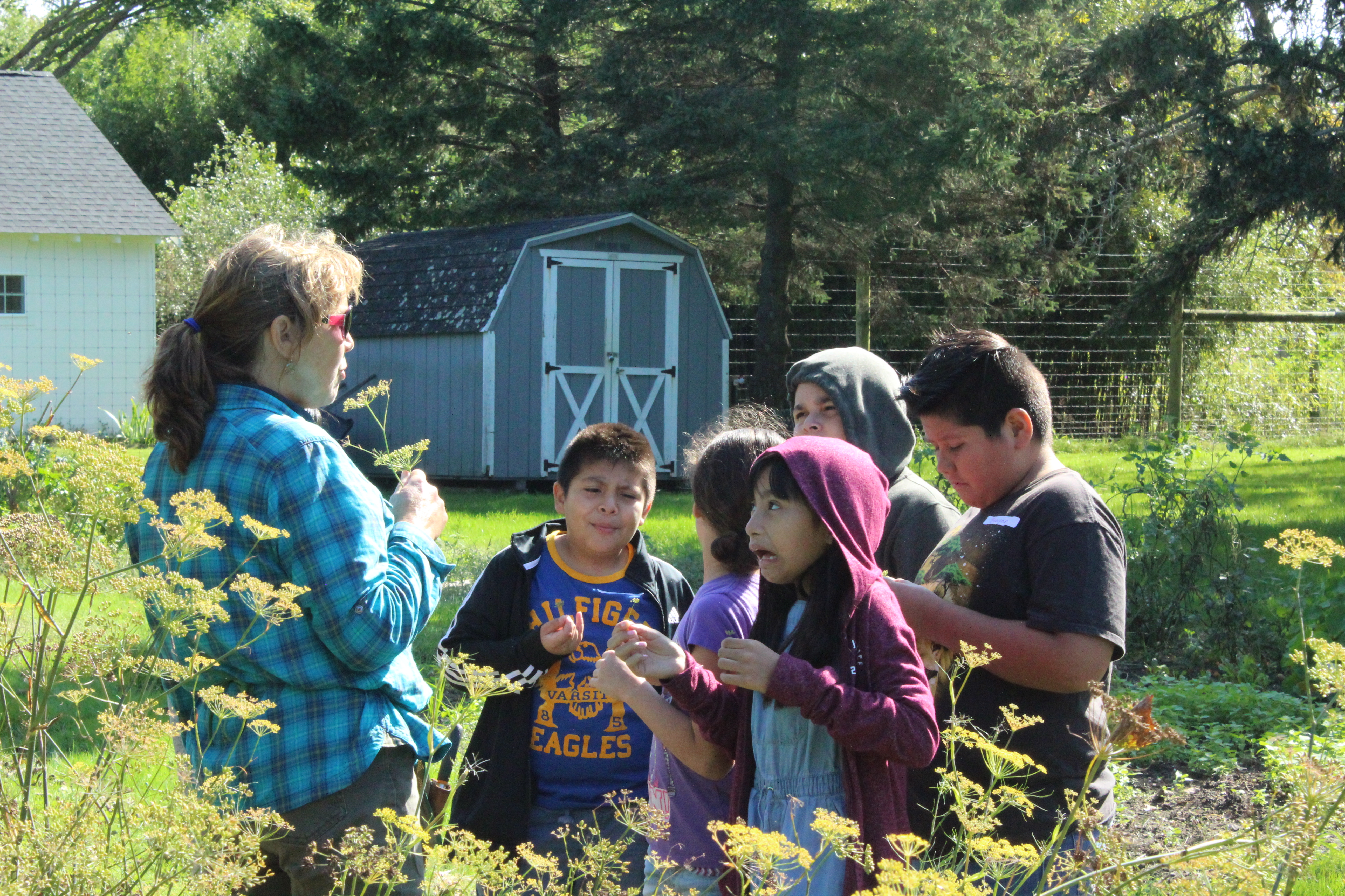 Denise leading a class tour in the garden