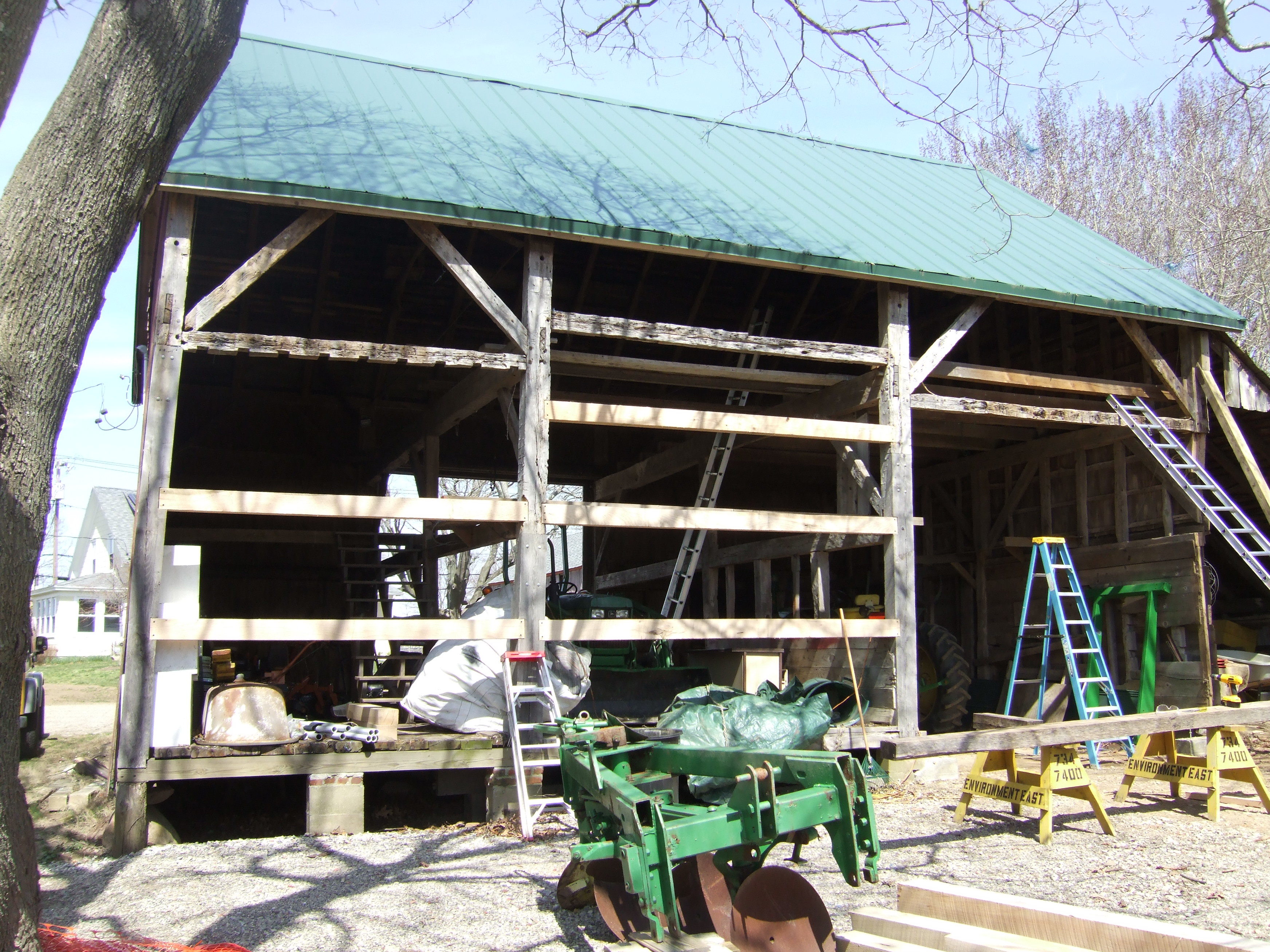 equipment in front of the exposed barn