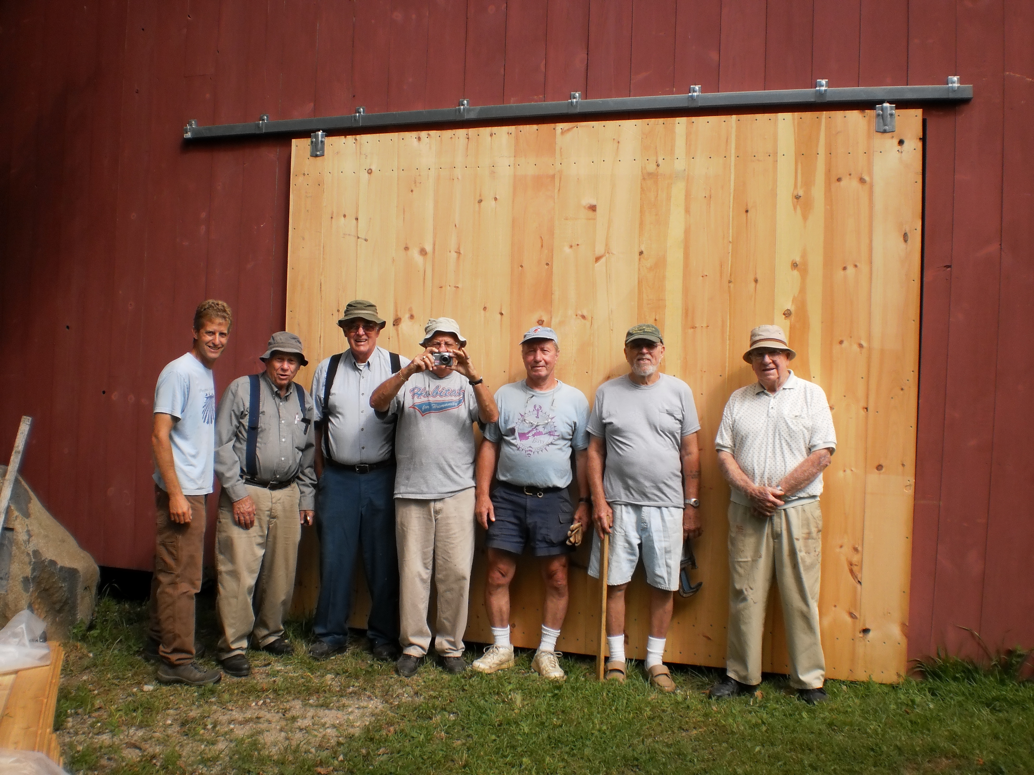 volunteers in front of barn